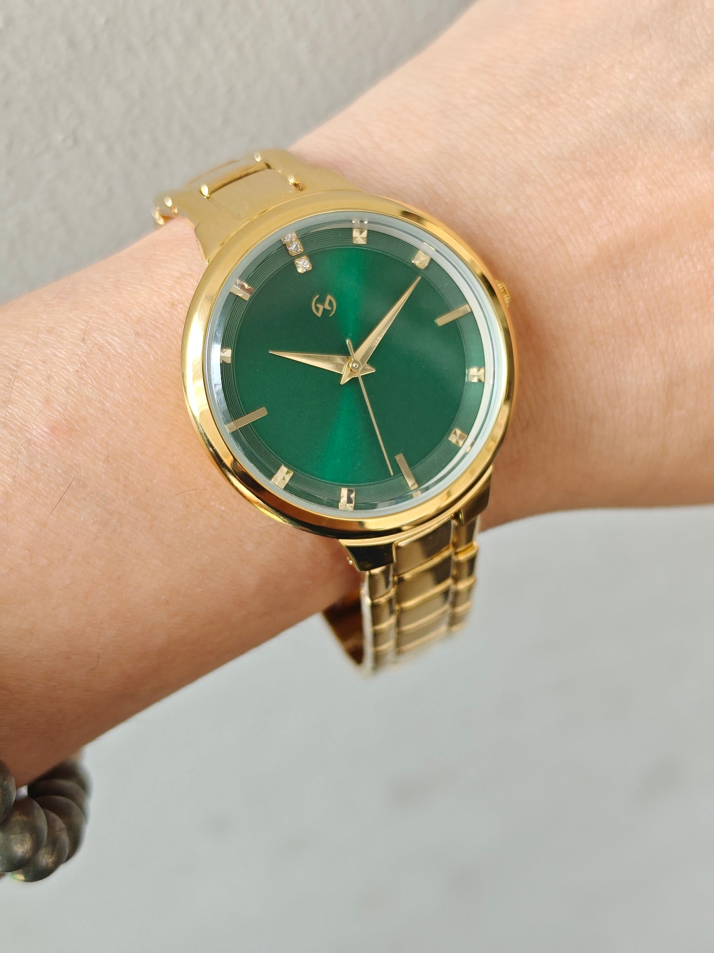 Bestseller gold watch with green sunray dial