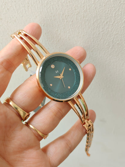 Modern yet traditional bangle style green dial watch with sparkling dial