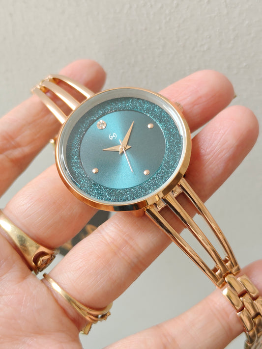 Modern yet traditional bangle style green dial watch with sparkling dial