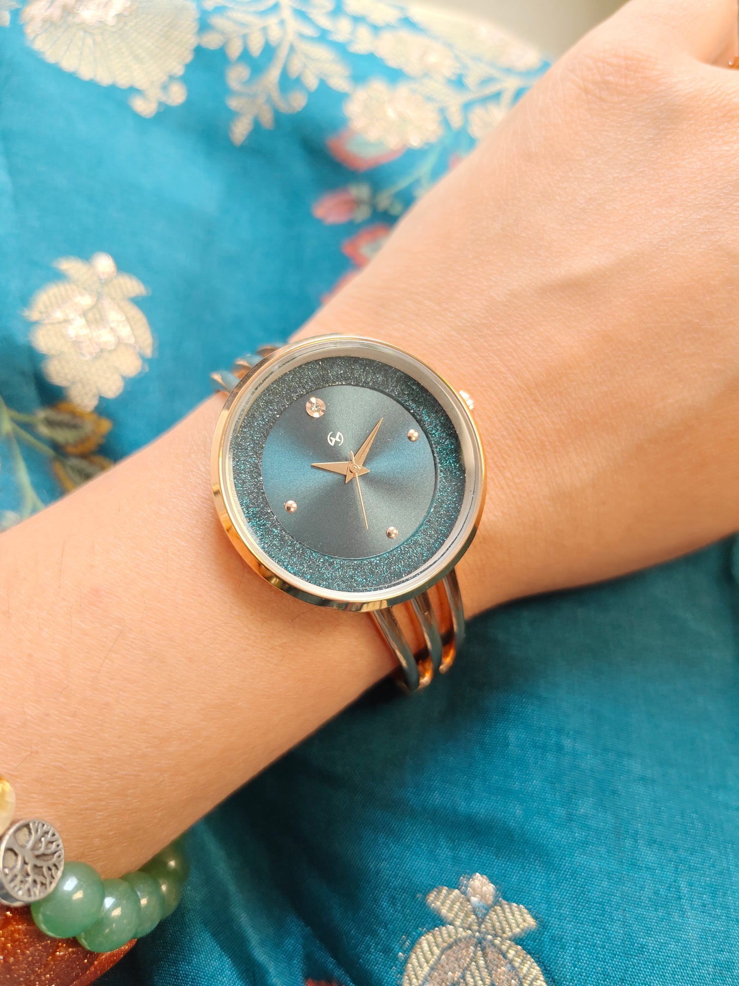 Modern yet traditional bangle style green dial watch with sparkling dial
