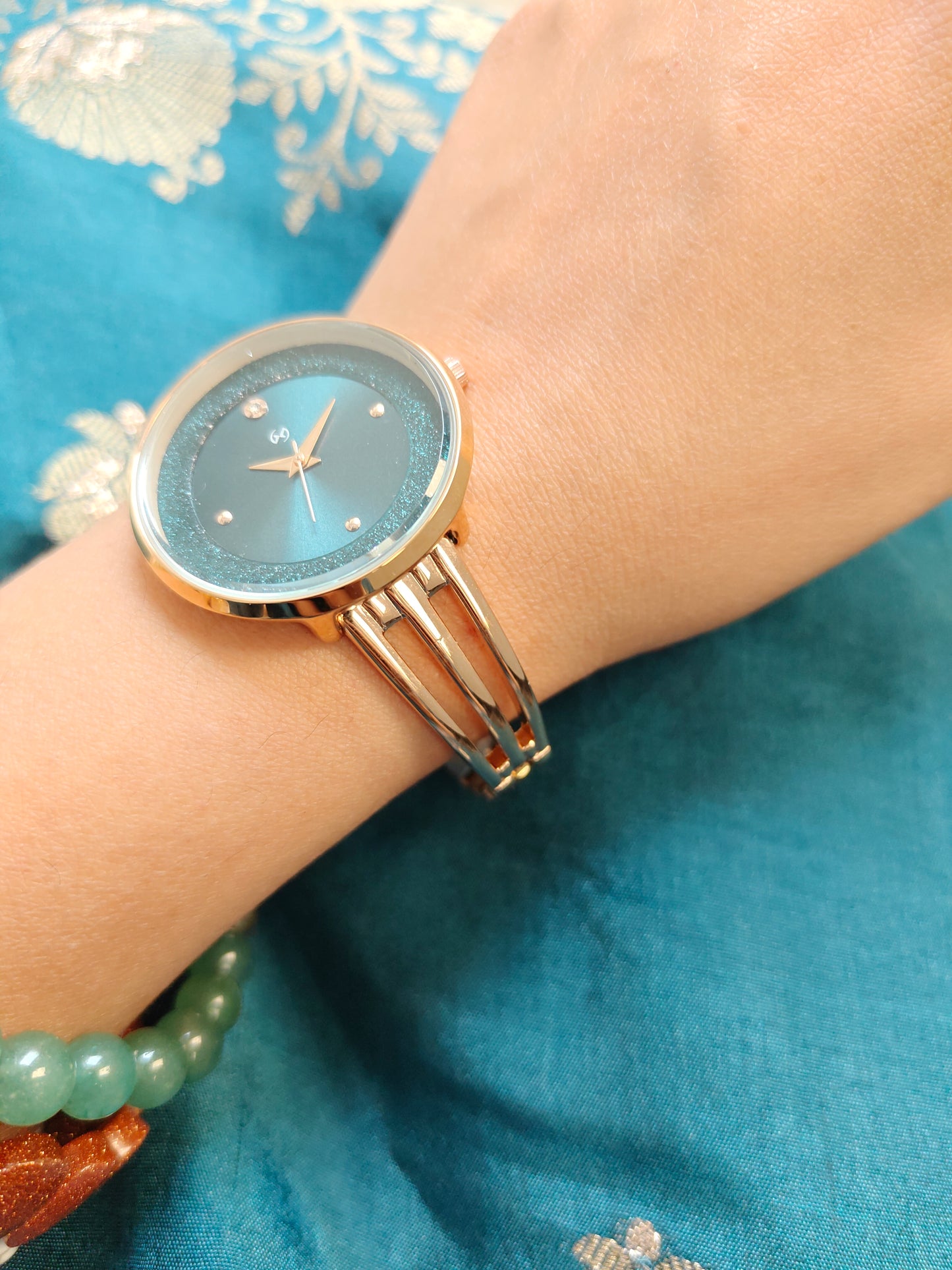 Modern yet traditional bangle style green dial watch with sparkling dial