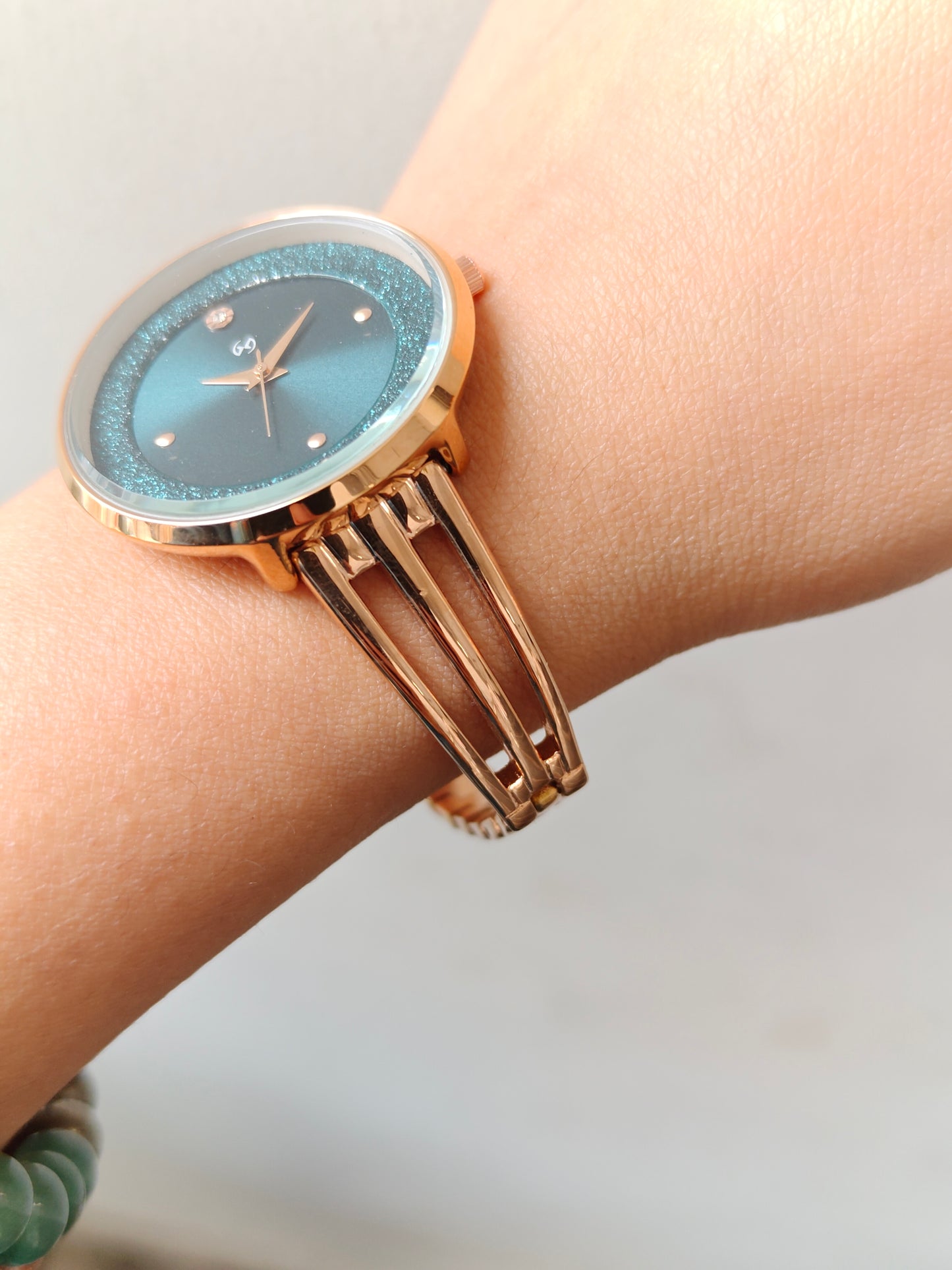 Modern yet traditional bangle style green dial watch with sparkling dial