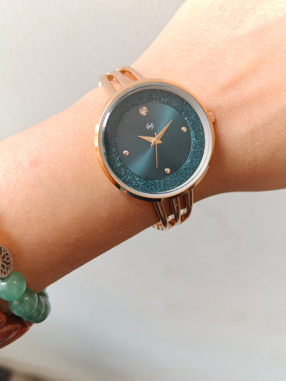 Modern yet traditional bangle style green dial watch with sparkling dial