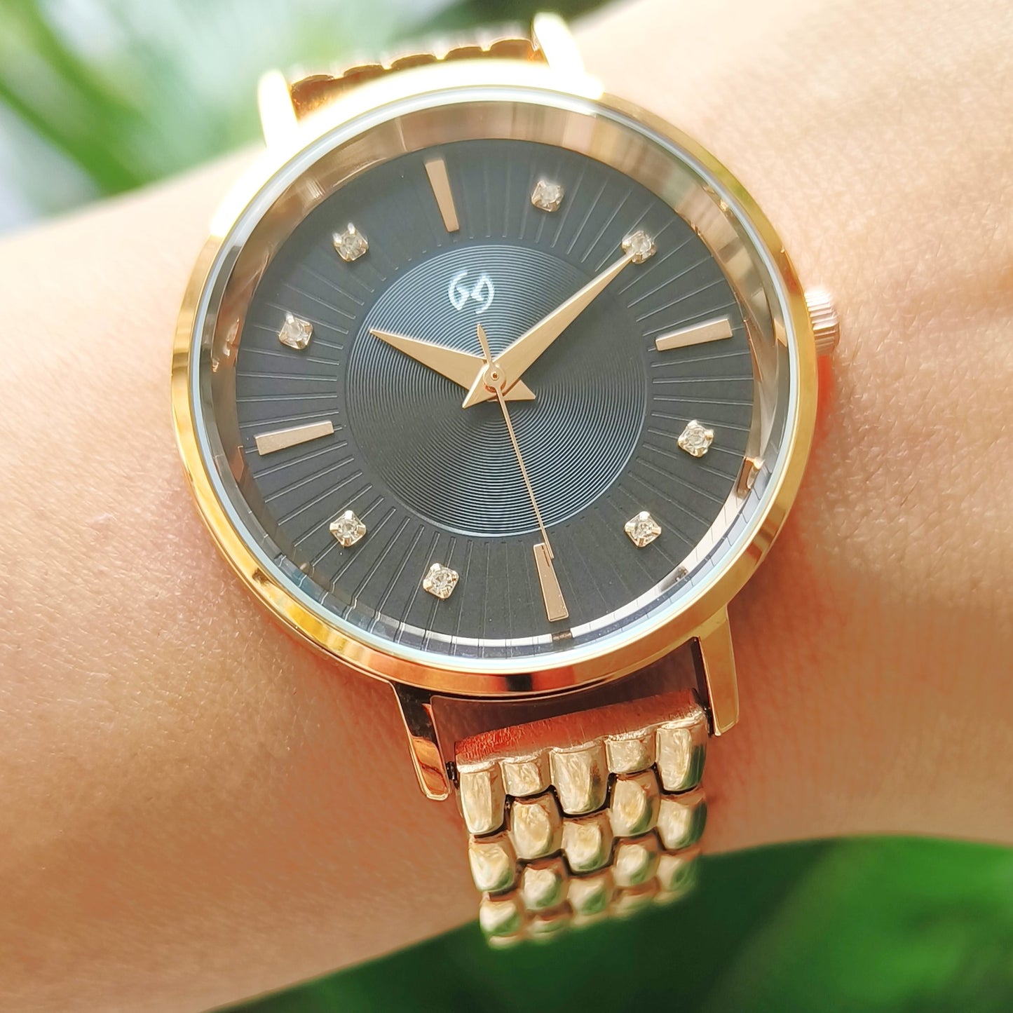 Rose gold watch with black embellished and textured dial featuring European style chain for women